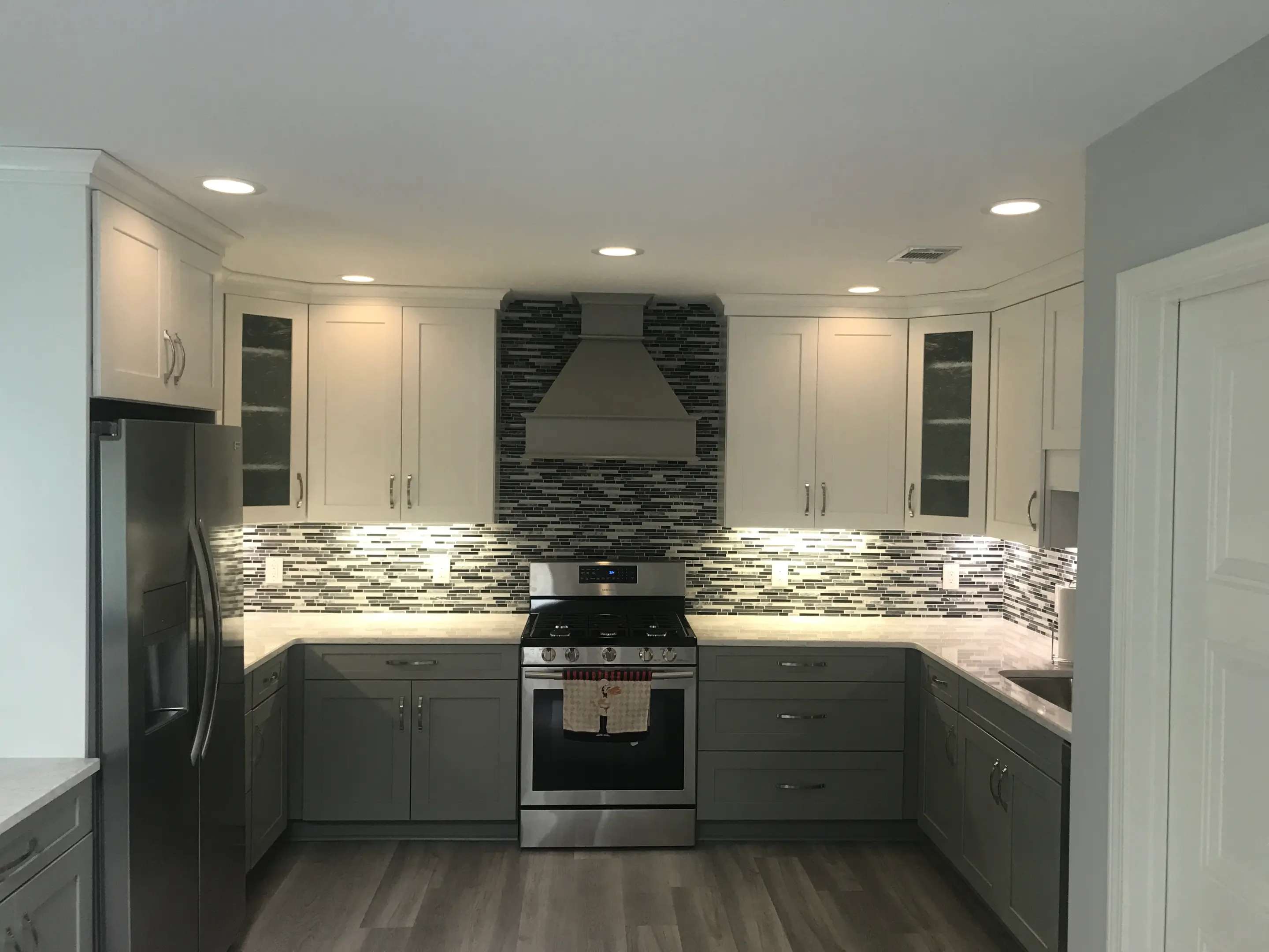 A kitchen with custom cabinets and custom cabinetry