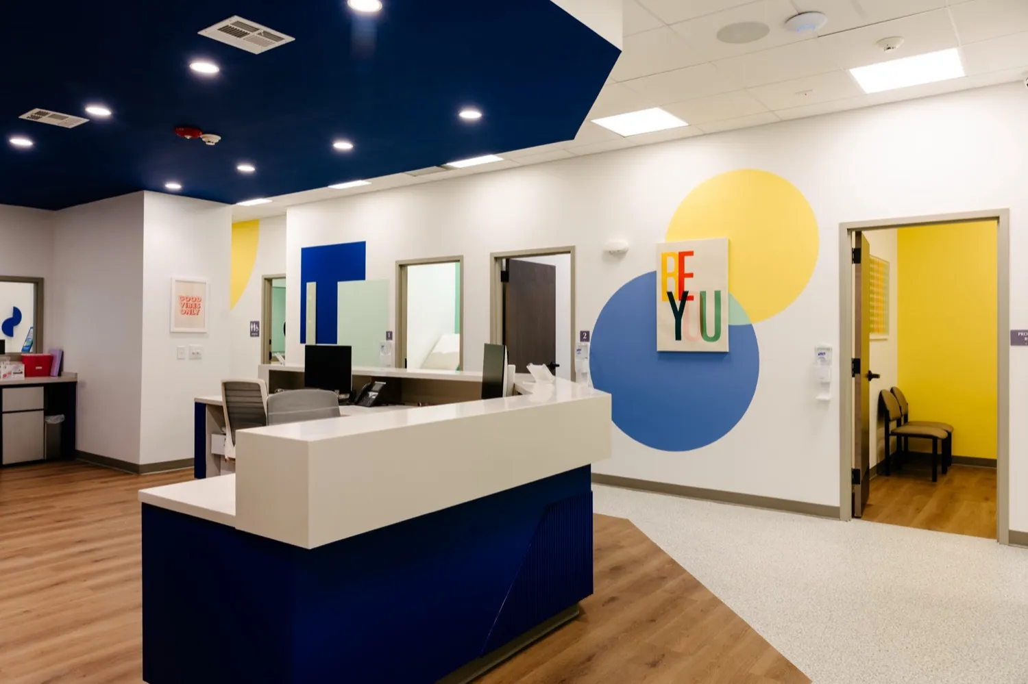 The bright, colorful Care+ Pediatrics Urgent Care lobby and check-in desk