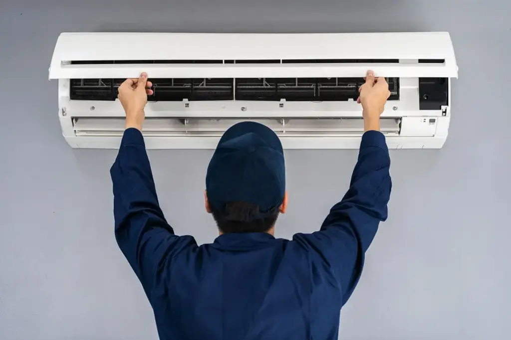 Mini-split systems for targeted cooling in Opelika AL, technician installing a new mini split