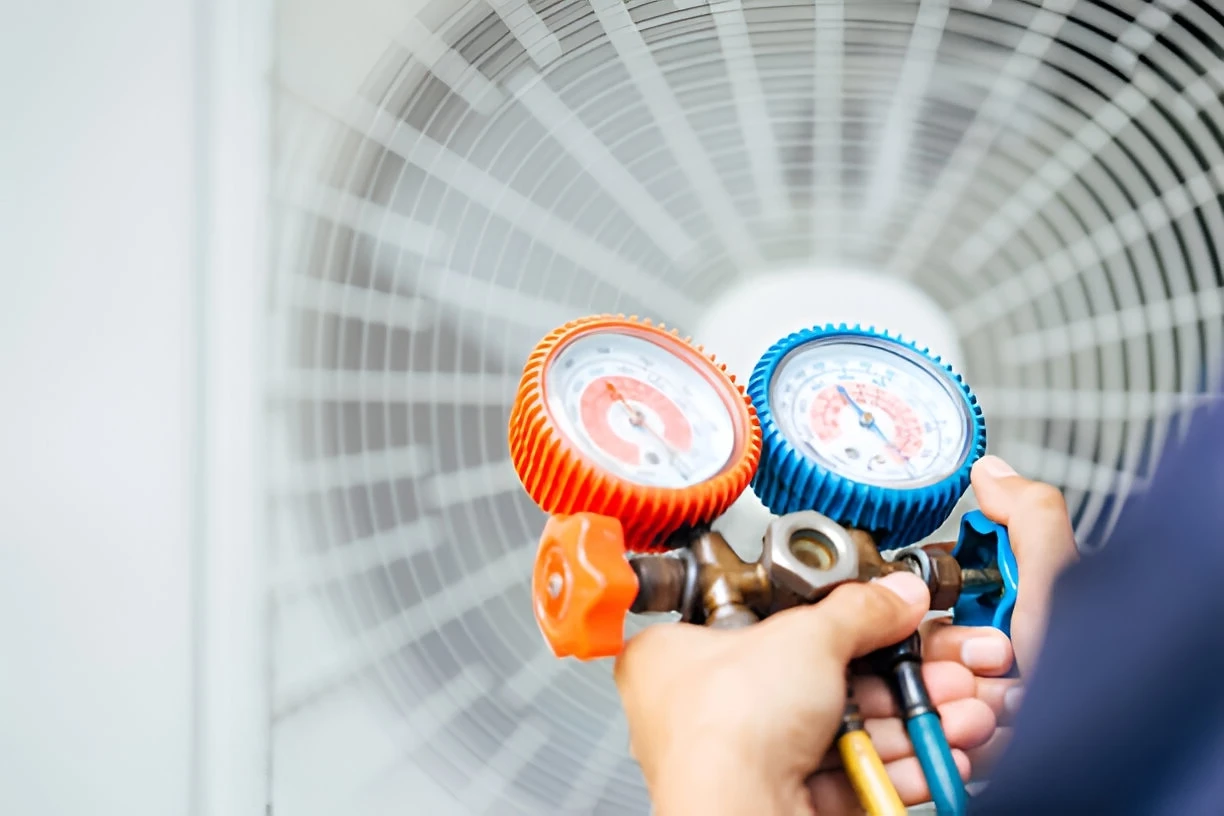 HVAC technician using a manifold gauge