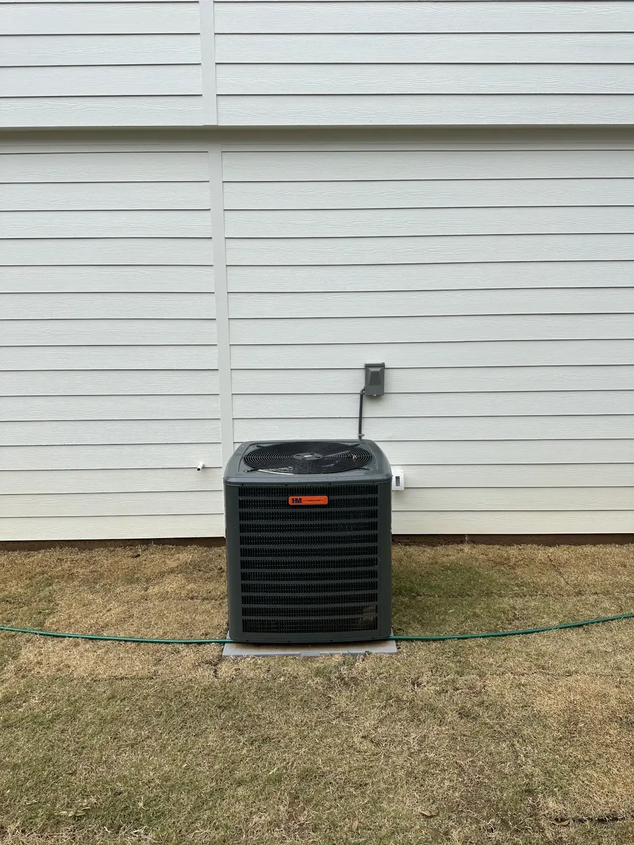 Outdoor air conditioning unit with Harmon Mechanical branding
