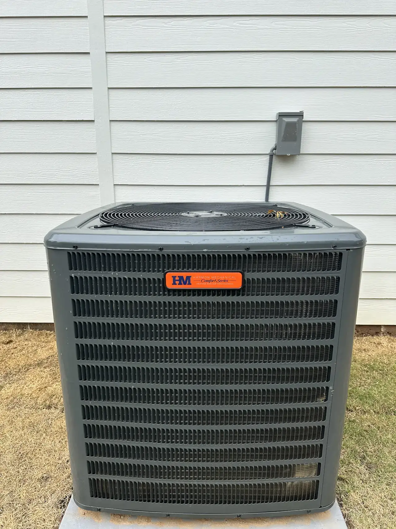 heat pump or air conditioner outdoor unit with Harmon Mechanical branding