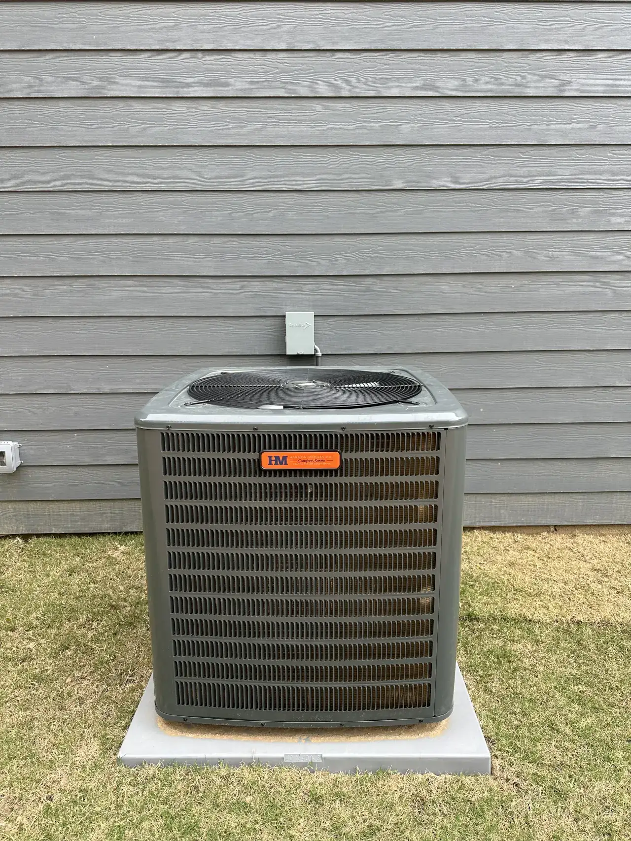 outdoor HVAC condenser unit with Harmon Mechanical branding