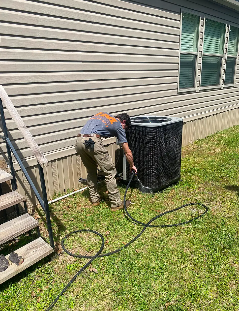Harmon Mechanical team performing maintenance on a heat pump