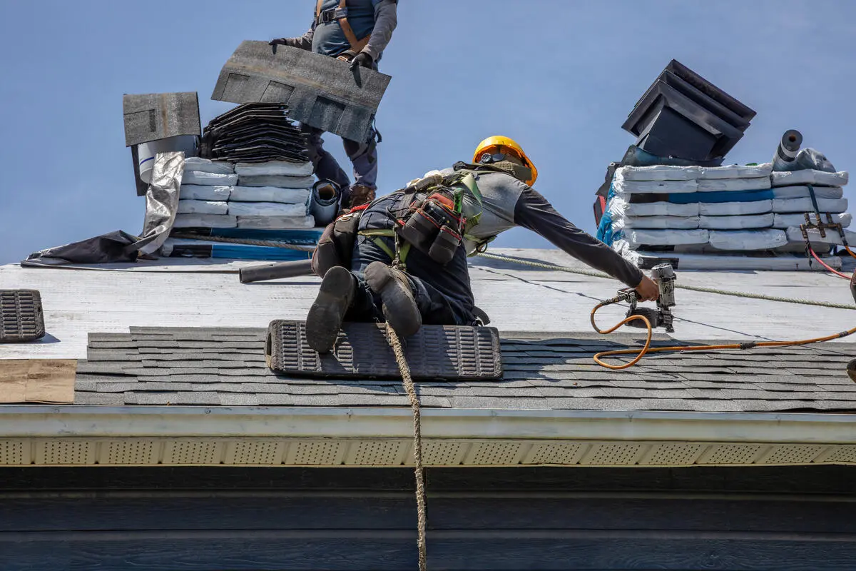 guy installing new roof using protection