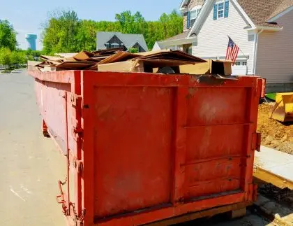 Red roll off container used for residential dumpster rental services