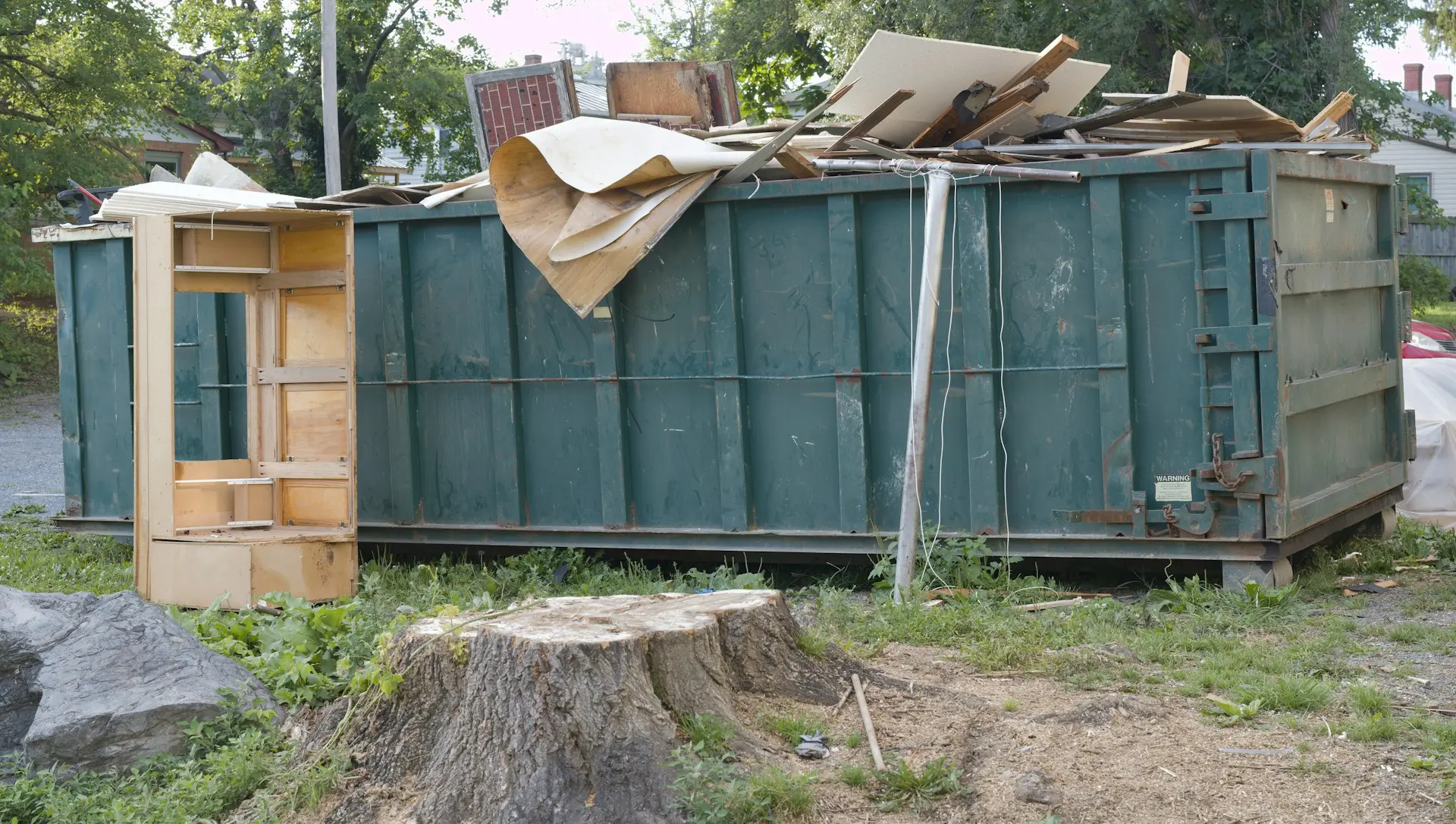 Large green bin highlighting options for small dumpster rentals