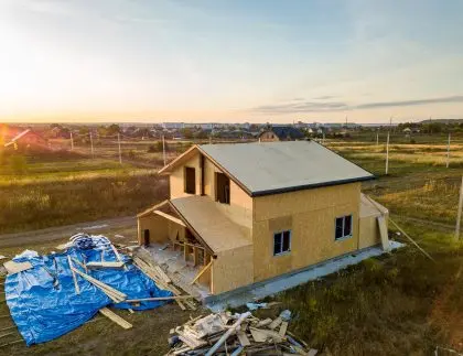 Home construction site requiring a dumpster for scattered lumber debris