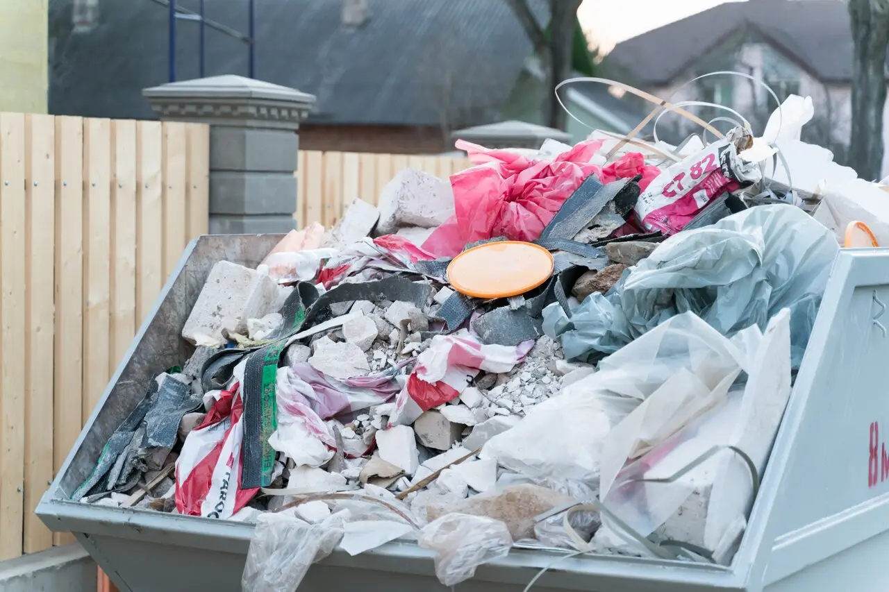 Overflowing container from residential dumpster rental services for concrete debris
