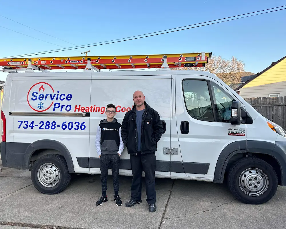 Owner and son standing by a company van