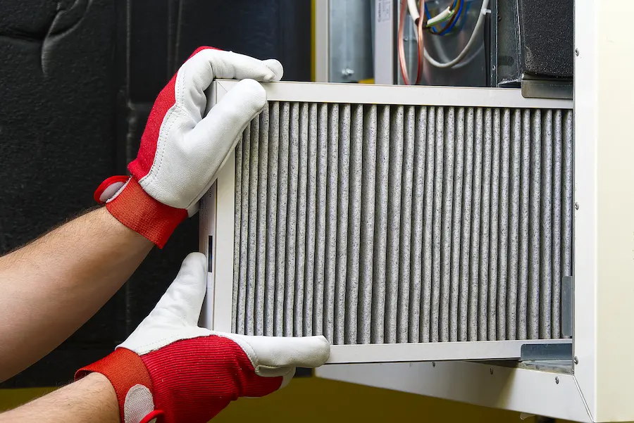 HVAC worker replacing ac filter