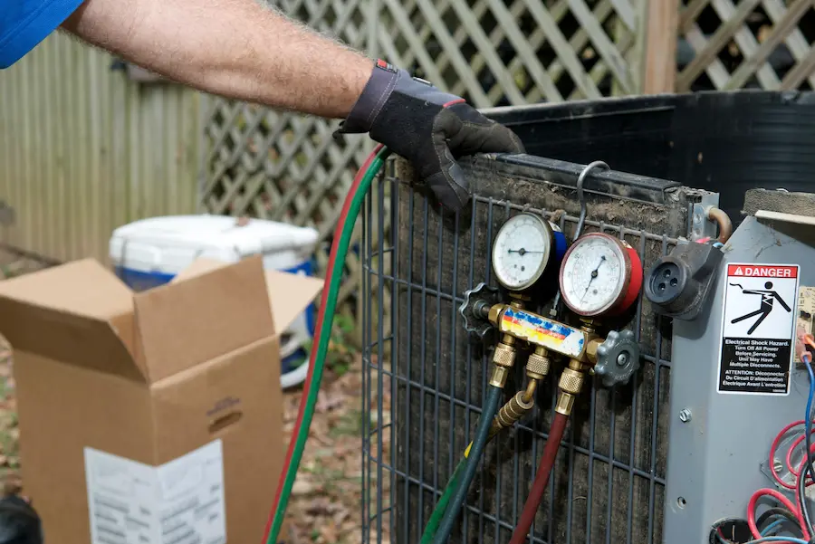 hvac worker performing an ac repair