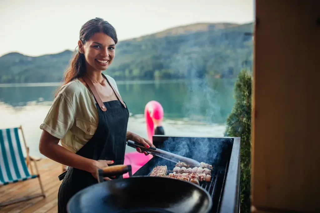 Woman using bbq outdoors