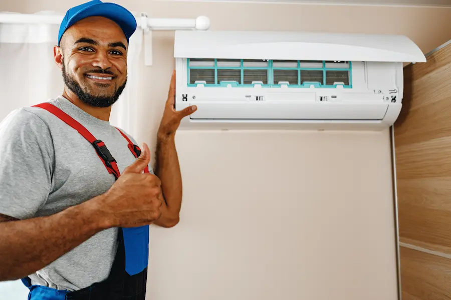 hvac worker installing a ductless heating system