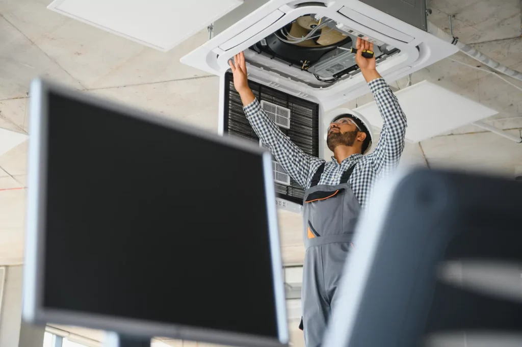 Hvac worker inspecting vent