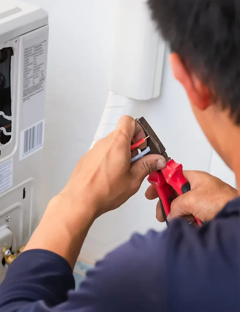 Hvac Worker cutting ac unit cables
