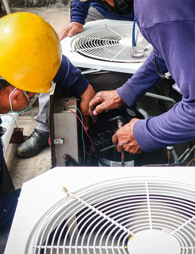 Hvac professionals working on heat pump