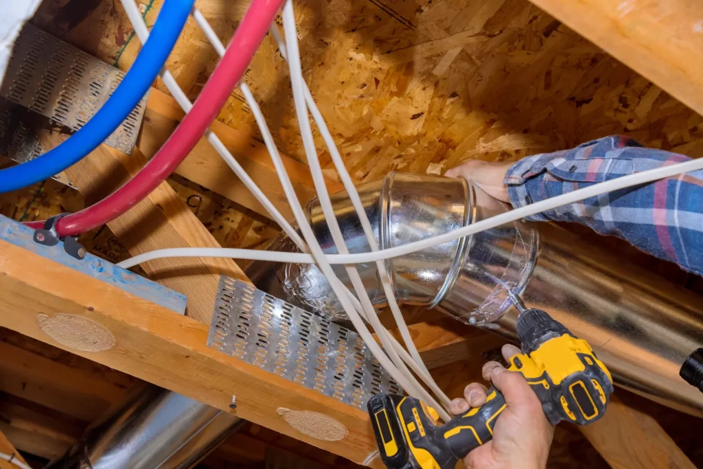 hvac worker fixing ducts