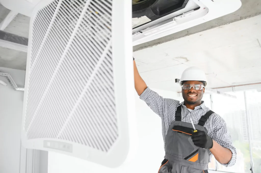 hvac worker inspecting open vent