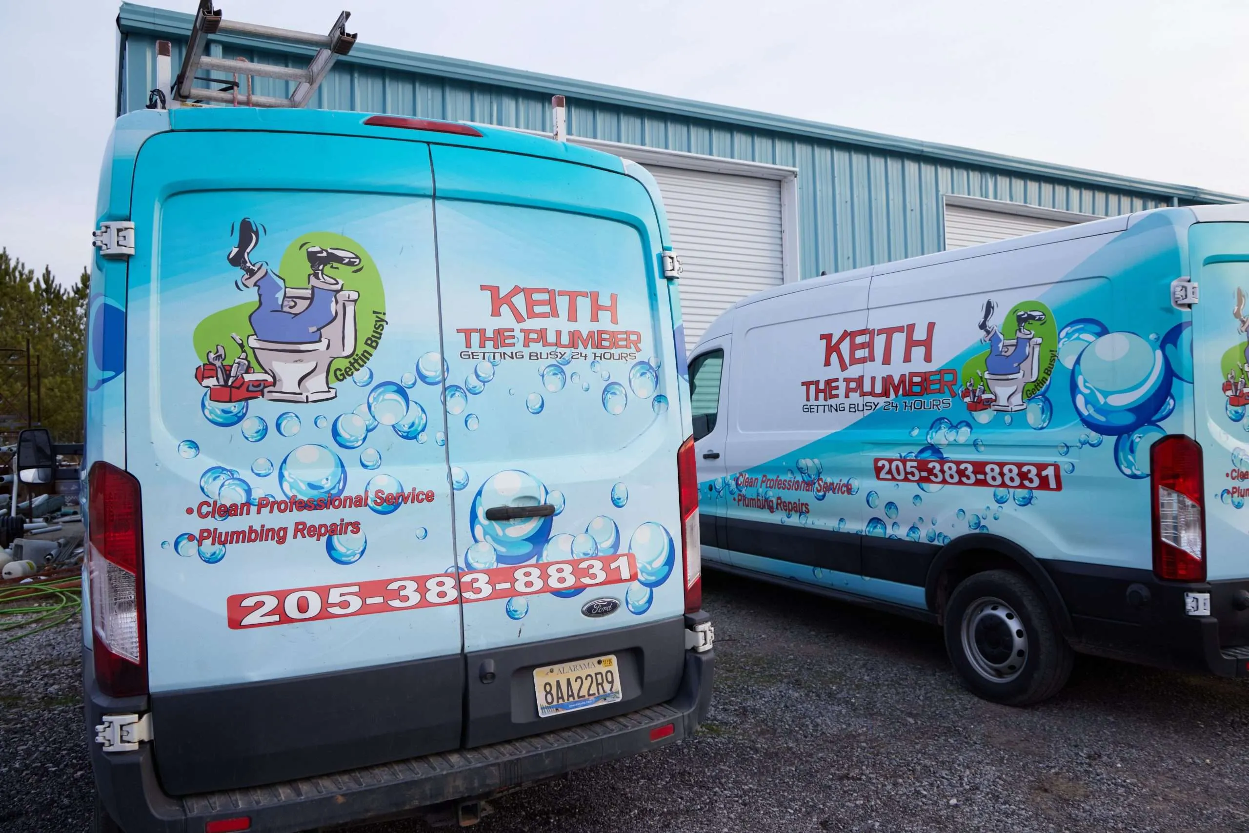 Two white Keith The Plumber Ford Transit service vans with a blue bubble-themed wrap