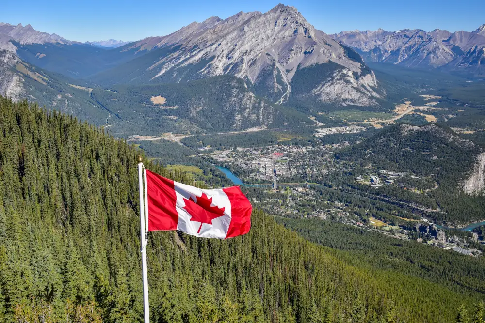 Energy Advisors Helping Create Sustainable Solutions in Canada - Canada flag with Canadian rocky mountain at the background