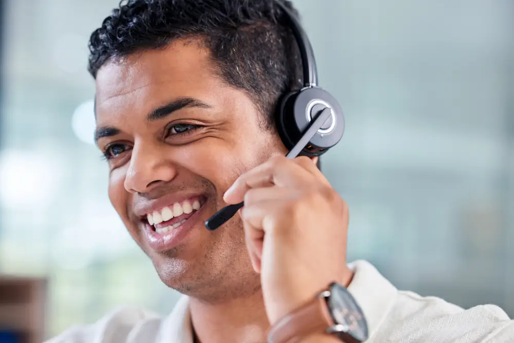 How Much Does An Energy Advisor Make In Canada - Smiling man wearing a headset for a phone call.