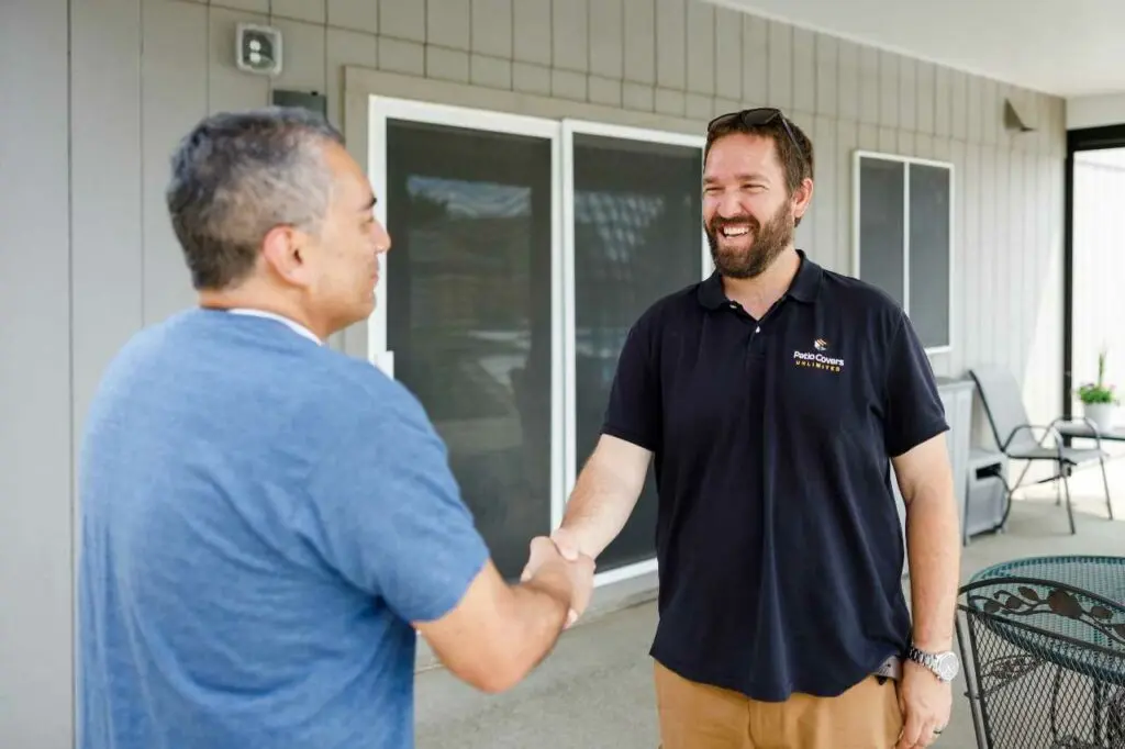 Patio Covers Unlimited shaking hands with client