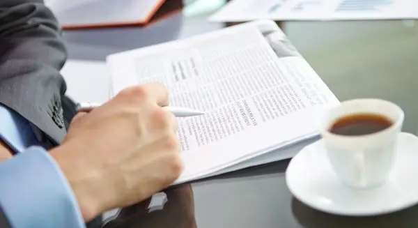 close-up-male-executive-reading-news@2x