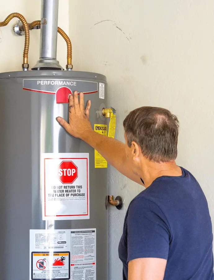 Man inspecting a water heater