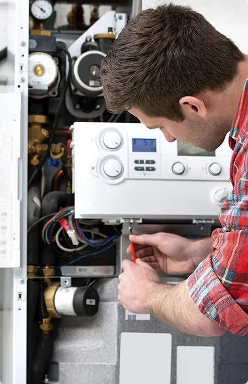 Technician inspecting boiler