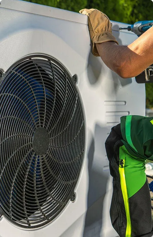 Technician installing a heat pump