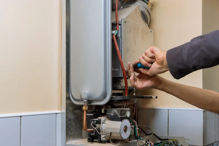 plumber servicing a central heating