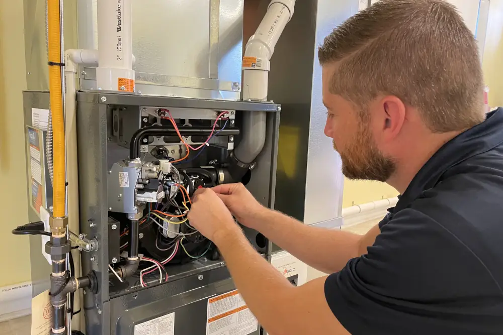 Furnace Maintenance Checklist - Shipton's technician doing maintenance on a furnace.