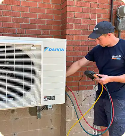 HVAC Contractor working on an external unit of a heat pump or ac system