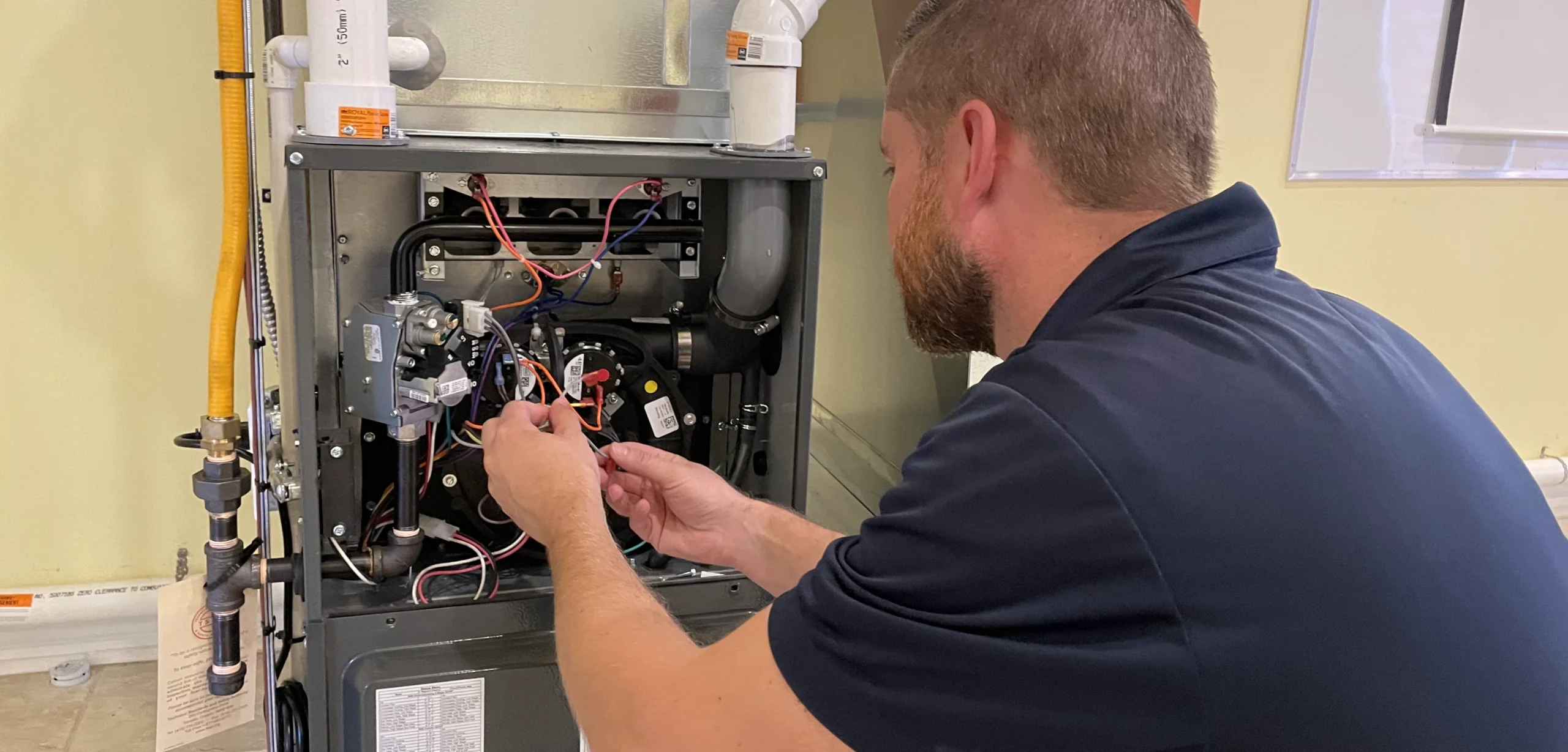 Furnace Maintenance - Shipton's HVAC technician working on a furnace.