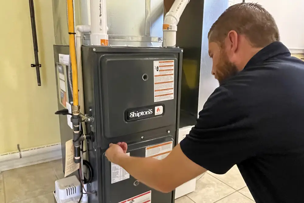 Technician inspecting a furnace for common issues