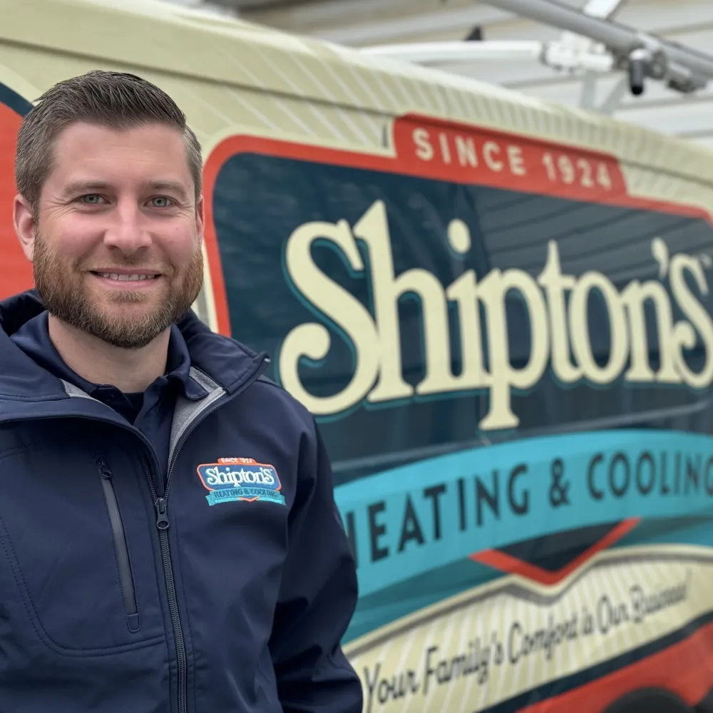 Scott Shipton standing next to company branded truck.