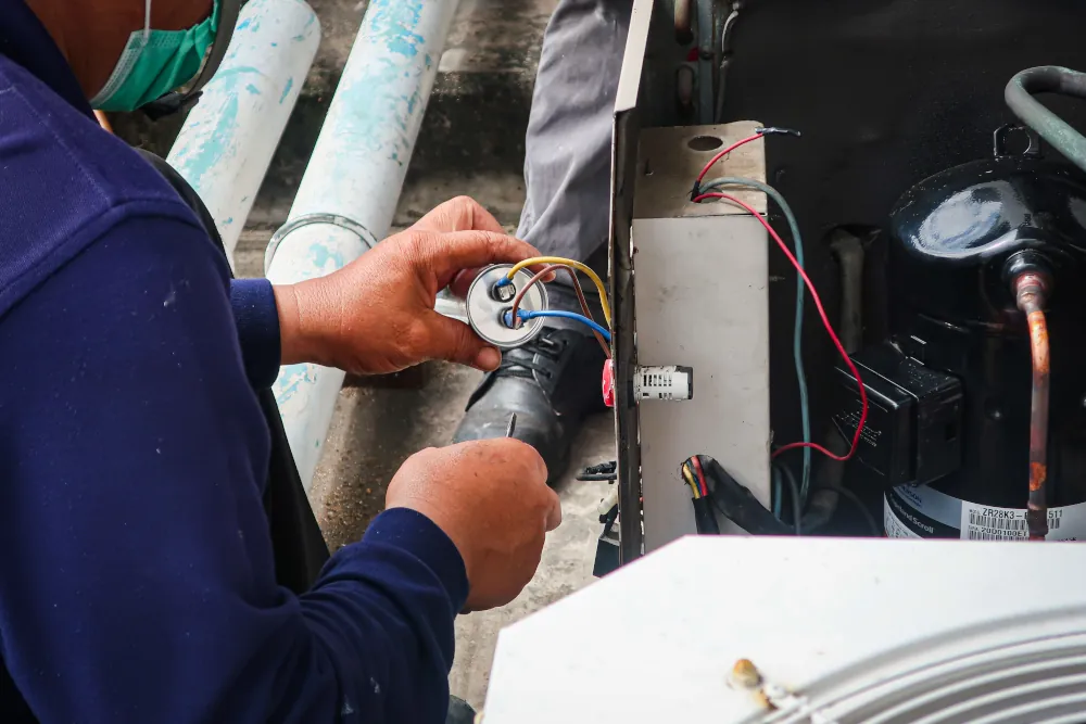 HVAC technician performing a tune-up on an AC Unit.