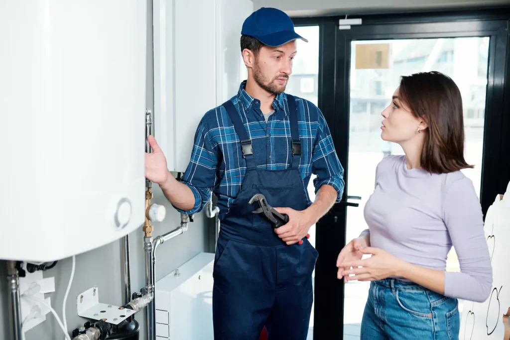 plumber explains work to woman