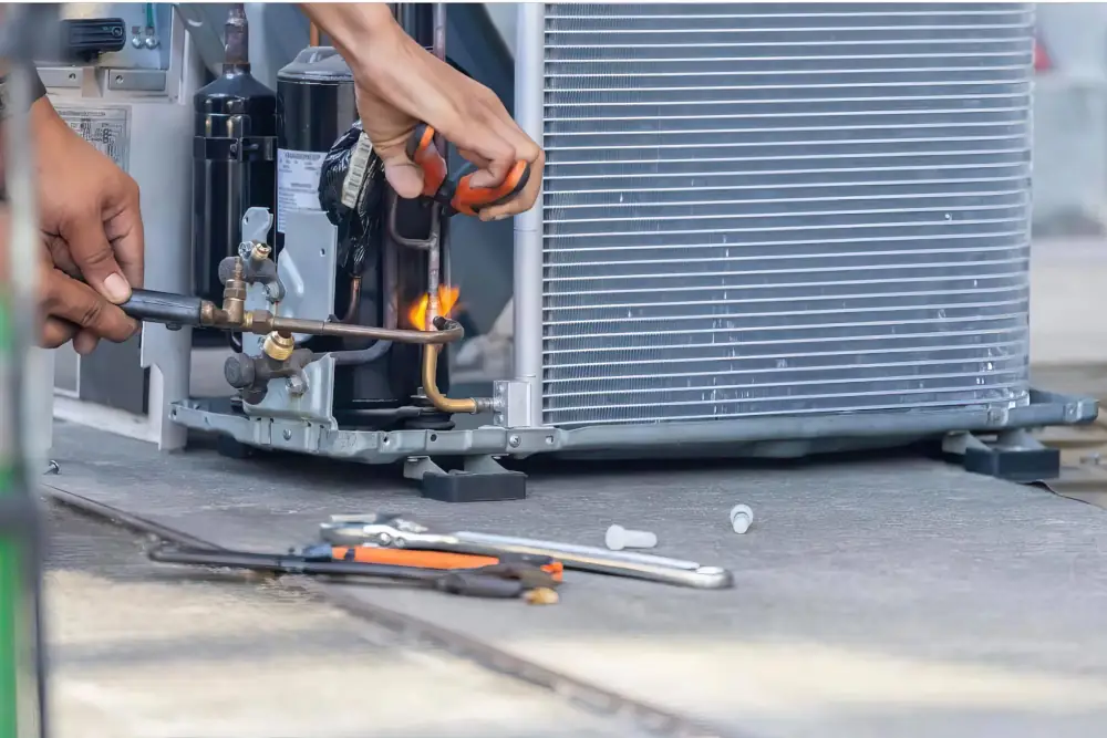 Air Conditioner Repair in London Ontario - Picture of an HVAC technician working on an AC unit.