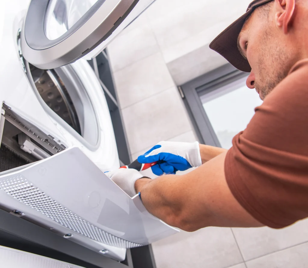 Repairman working on a Dryer