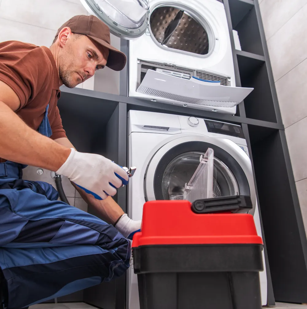 Dryer Repair Services In London, ON - Repairman fixing a dryer