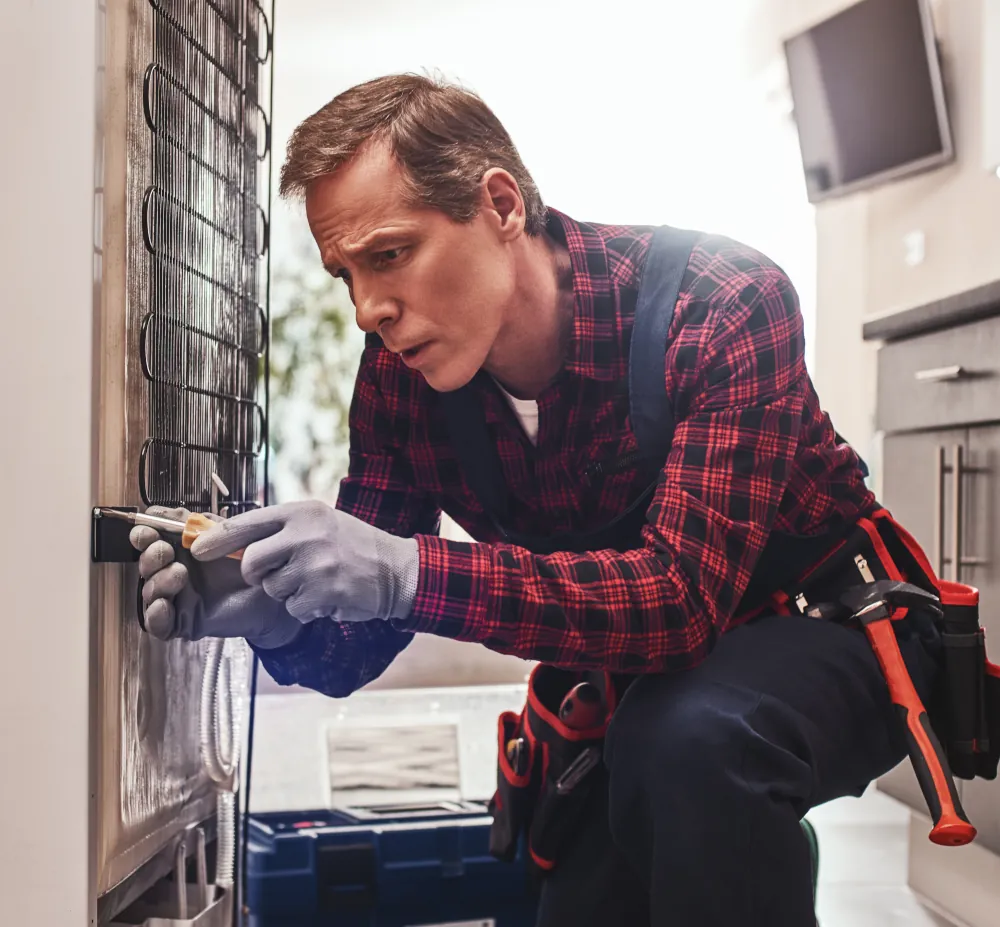 Fridge Repair Services in London ON - HVAC technician working on a fridge