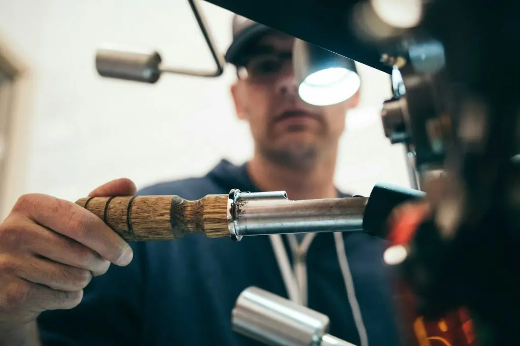 Technician brazing a copper pipe with a torch