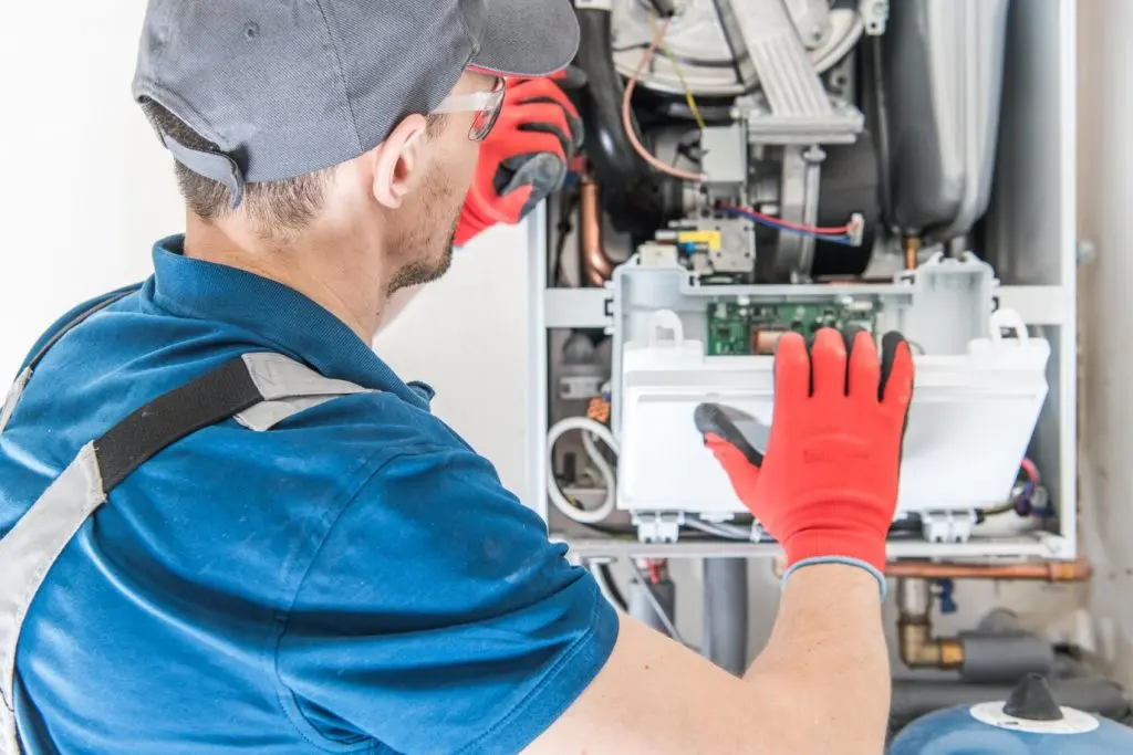 technician handling gas furnace
