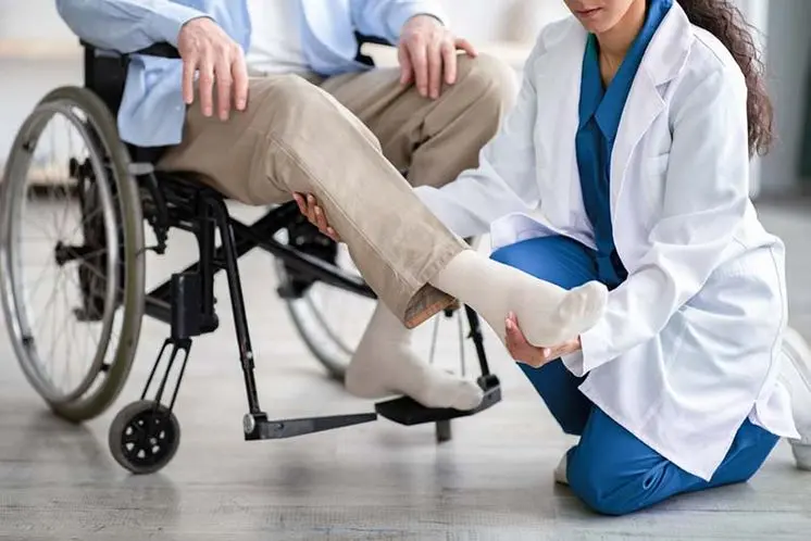Personal injury lawyer helping a client understand the legal, medical, and financial steps to take after being paralyzed in a car accident | What to Do After Being Paralyzed in a Car Accident