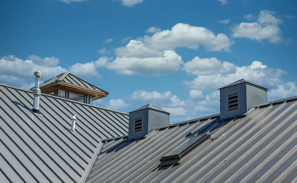 metal roofing kalispell mt-gray standing seam metal roofing on a home with blue sky background