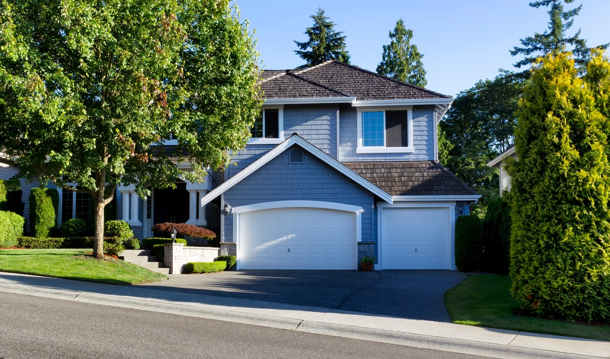 A gray house with a synthetic cedar shake roof.