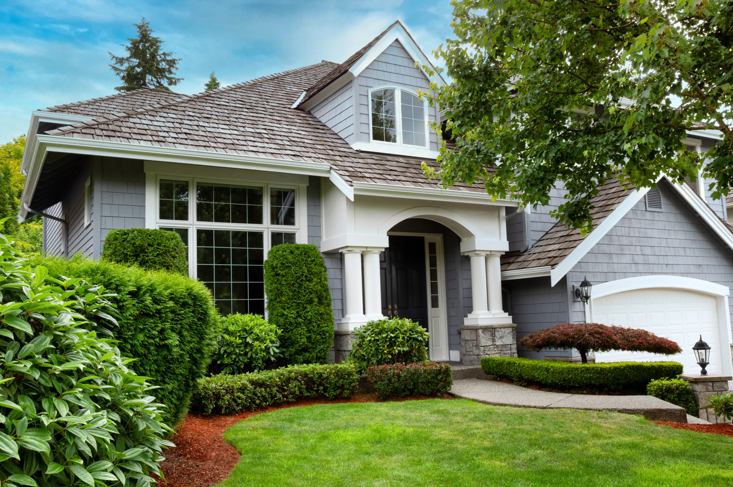 a home with nice yard and cedar shake shingles