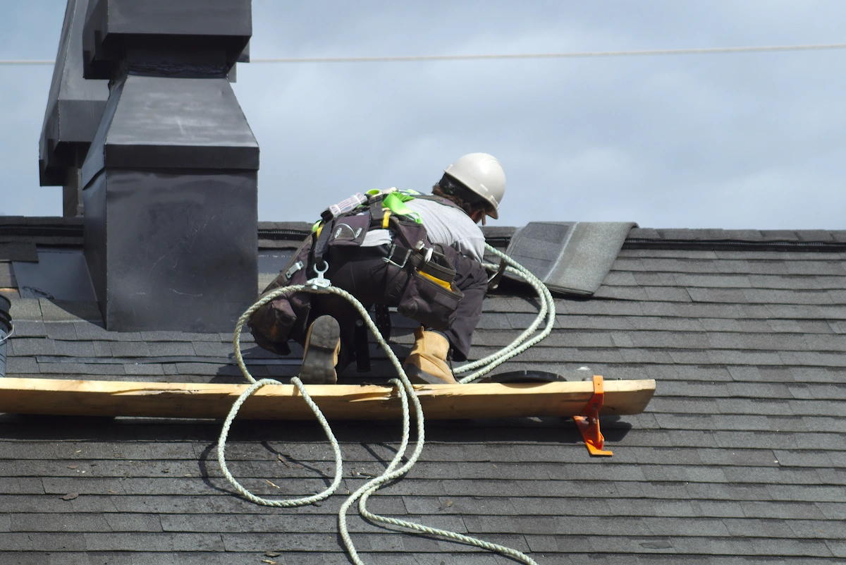 a roofer completing a shingle installation